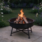 Folding fire bowl with a log fire burning at dusk in an open garden