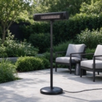 Freestanding infrared patio heater on a telescopic pole beside lounge armchairs