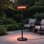 Freestanding heater glowing at dusk beside the armchairs