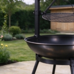Close-up of the swing-arm grill and upright post of the fire pit