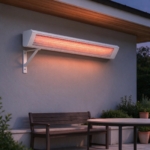 White wall heater glowing at dusk above a covered terrace